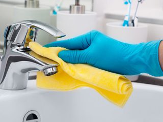 30796776 - woman doing chores in bathroom, cleaning tap